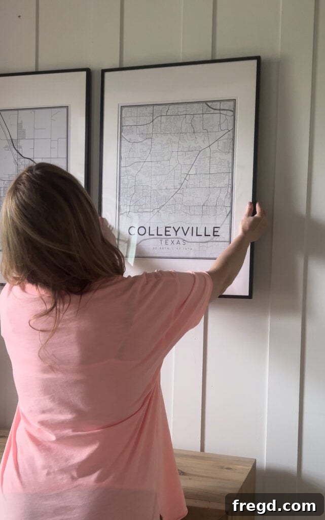 DIY Map Art Made Easy A Visual Walkthrough 9 Expertly hanging framed city map art on the wall using nails and strategic Command strips for stability and perfect alignment
