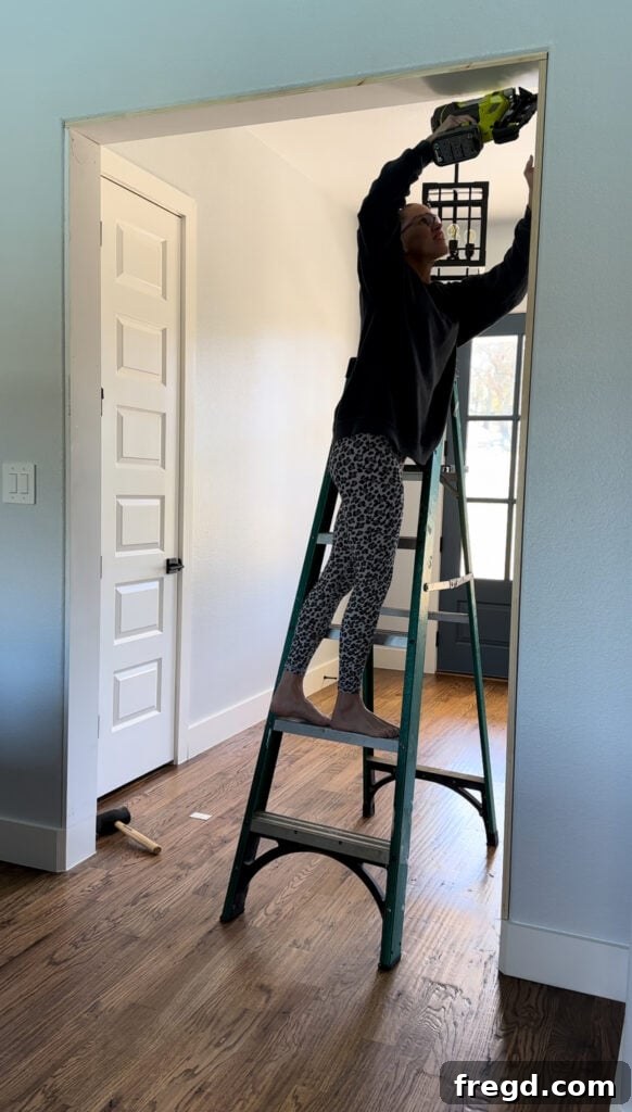 Installing the vertical interior frame board, ensuring it's flush with the top and base.