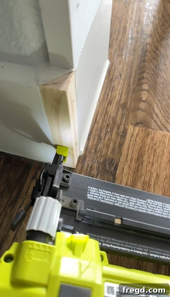 The new corner piece installed, creating a squared-off base molding look.