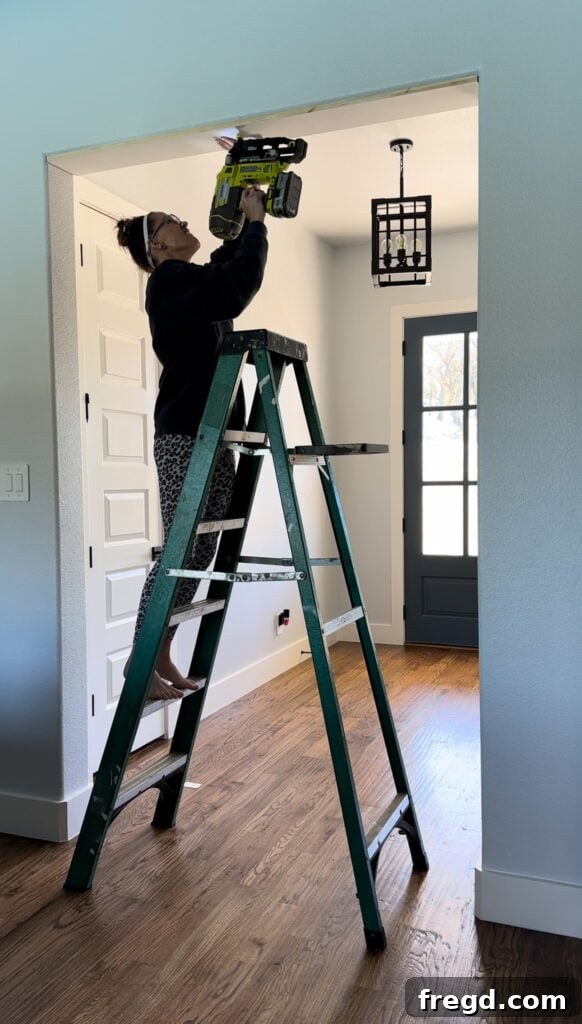 Securing the top interior frame board with a finish nailer.