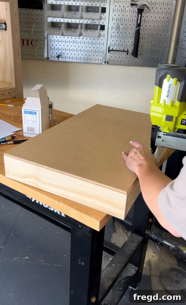 Drawer box with plywood base being attached
