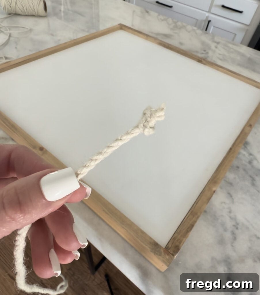 Nature's Eternal Canvas 14 Starting the jute rope design by hot gluing a knot to the bottom corner of the frame
