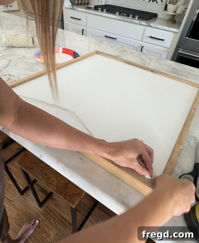 Nature's Eternal Canvas 16 Pulling the jute rope across the frame and gluing a loop to the opposite end
