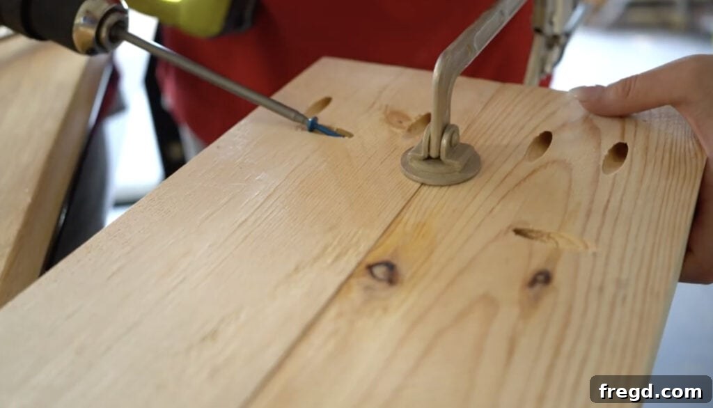 Applying wood glue before joining tabletop planks to ensure a strong bond.