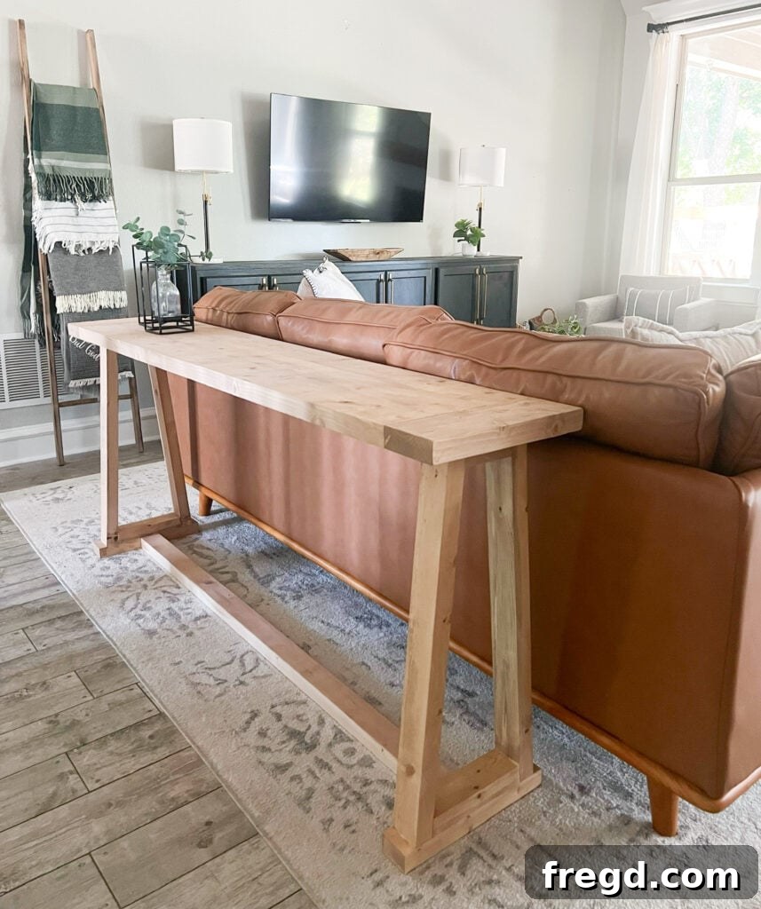 The completed DIY rustic modern console table in a stylish home setting.