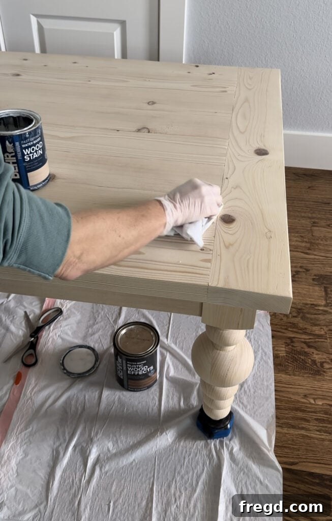 Applying the second coat, rustic brown stain, over the white wash