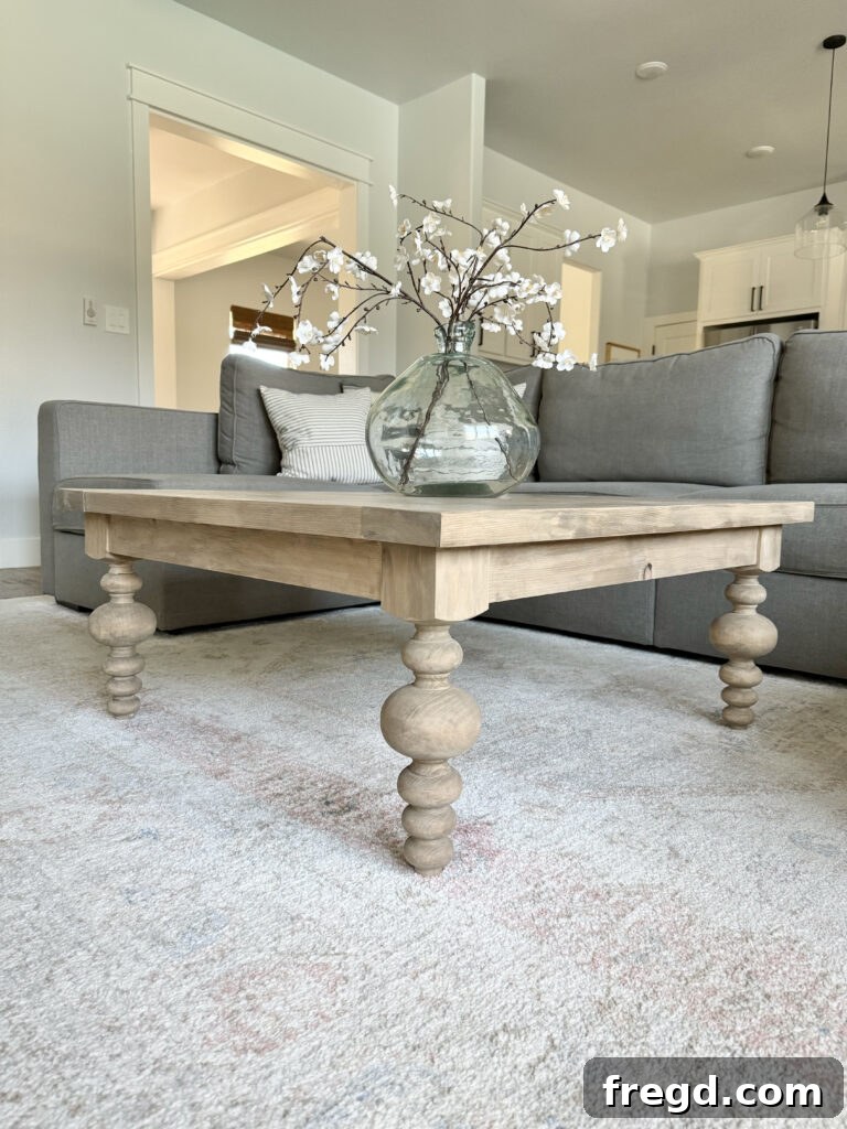 Close-up of the coffee table with decorative items, highlighting the turned legs