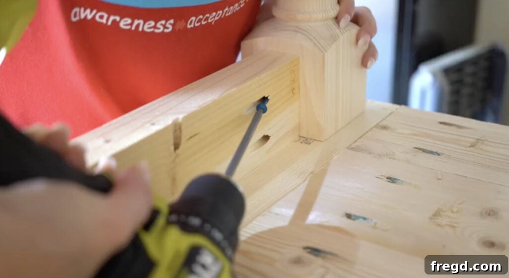 Assembling the table base by attaching apron pieces to the turned legs