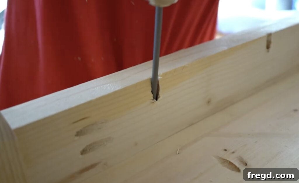 Securing the planked tabletop to the assembled table base