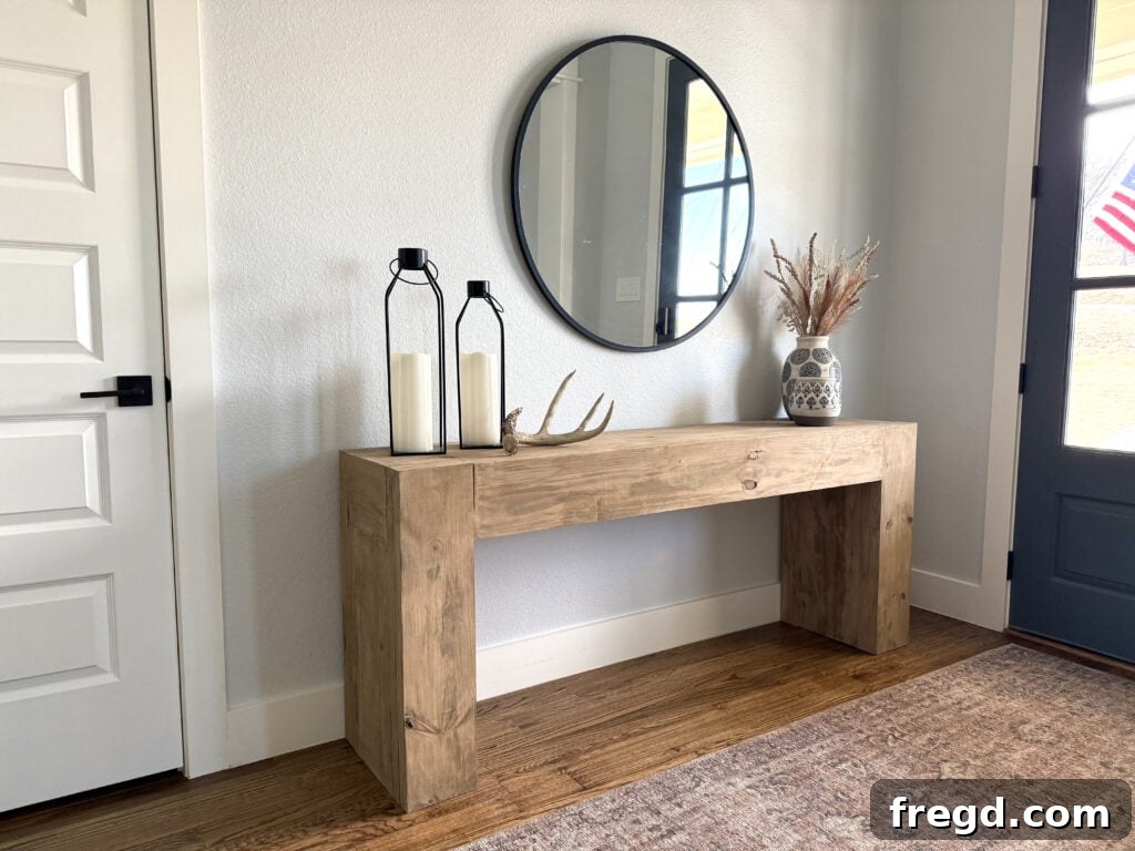Decorated entryway with custom chunky wood console table