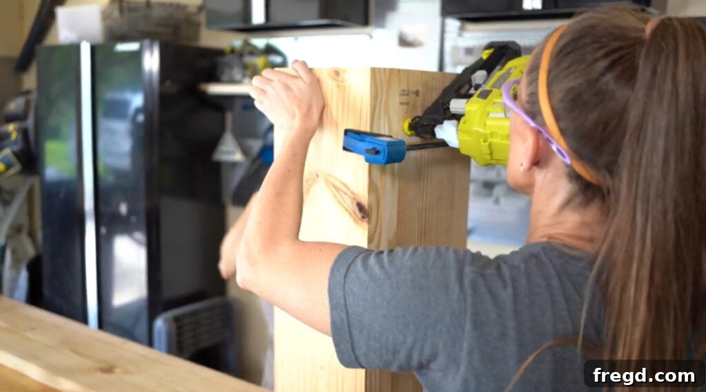 Attaching leg assemblies to outside panels with wood glue and finish nails