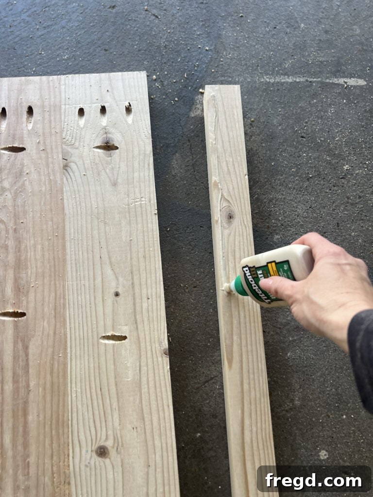 Build Your Own Twin Platform Bed 8 Detail of wood glue applied to the top edge of the bed frame before trim attachment.