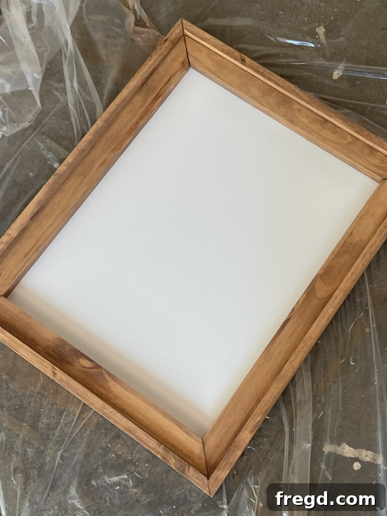 The back of an assembled wooden frame with the canvas panel securely stapled in place, showing a clean finish.