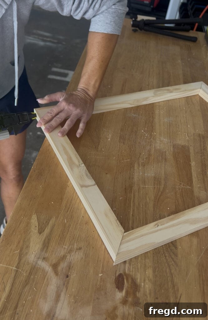 An assembled inner frame made from pine boards, showing four mitered corners glued and nailed.