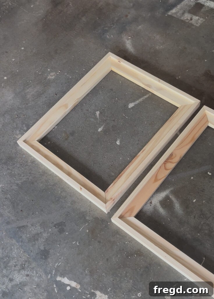 A wooden frame being stained with a dark wood stain using a rag, showing the rich color being applied.