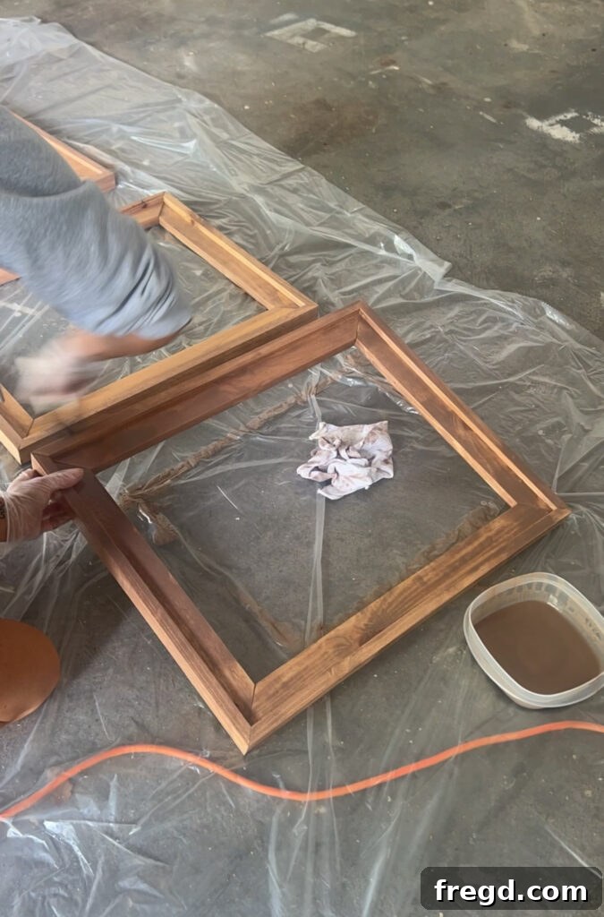 A stained wooden frame drying on a workbench, showcasing the finished wood grain and color.
