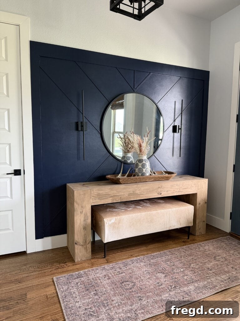 Removable Modern Accent Wall DIY for Renters 2 Stunning renter-friendly accent wall in a modern entryway, featuring deep navy geometric patterns and stylish decor.