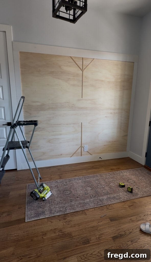 Removable Modern Accent Wall DIY for Renters 11 Measuring and cutting diagonal screen moulding pieces with 45-degree mitered ends.