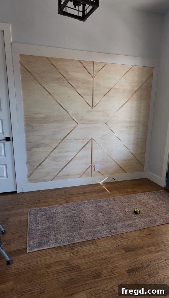 Removable Modern Accent Wall DIY for Renters 14 Applying wood filler to nail holes and preparing the accent wall for sanding and painting.