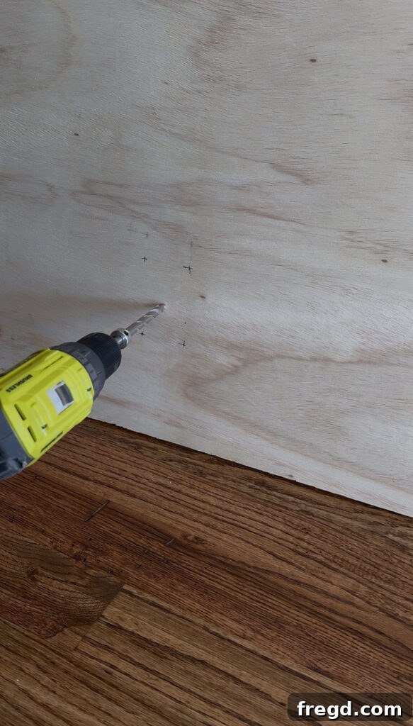 Removable Modern Accent Wall DIY for Renters 6 Cutting a plywood panel to fit inside the accent wall frame.