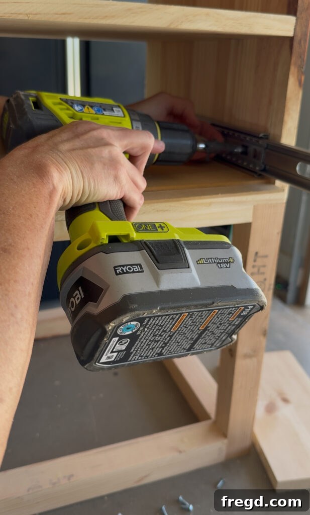 Easy Wood Nightstand Builds for Newbies 13 Outside half of a drawer slide being installed inside the nightstand cabinet, resting on a 1/4 inch scrap wood spacer.