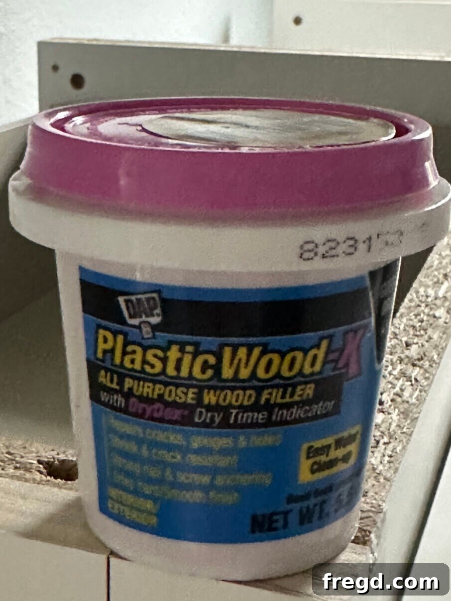Easy Wood Nightstand Builds for Newbies 16 Applying wood filler to nail holes and imperfections on the assembled nightstand.