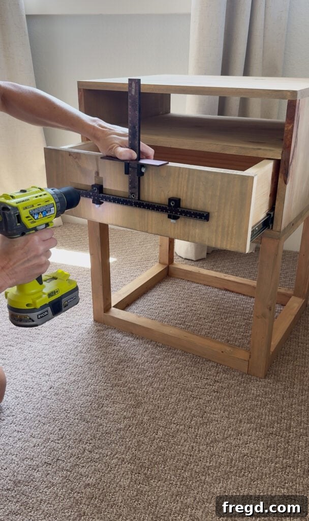 Easy Wood Nightstand Builds for Newbies 22 Using the Kreg KHI-XLPULL Cabinet Hardware Jig Pro to precisely drill holes for the drawer pull.