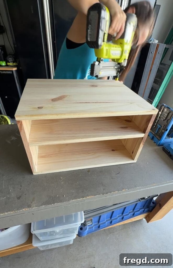 Easy Wood Nightstand Builds for Newbies 6 Top panel being attached to the nightstand frame using brad nails and wood glue.