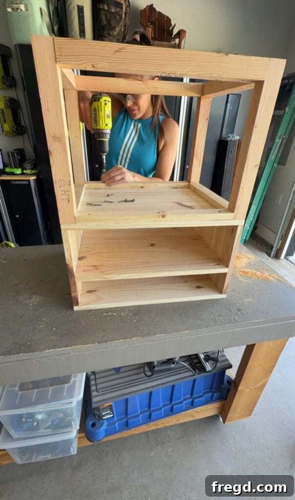 Easy Wood Nightstand Builds for Newbies 10 Drawer frame being flipped upside down and aligned with the base for final assembly.