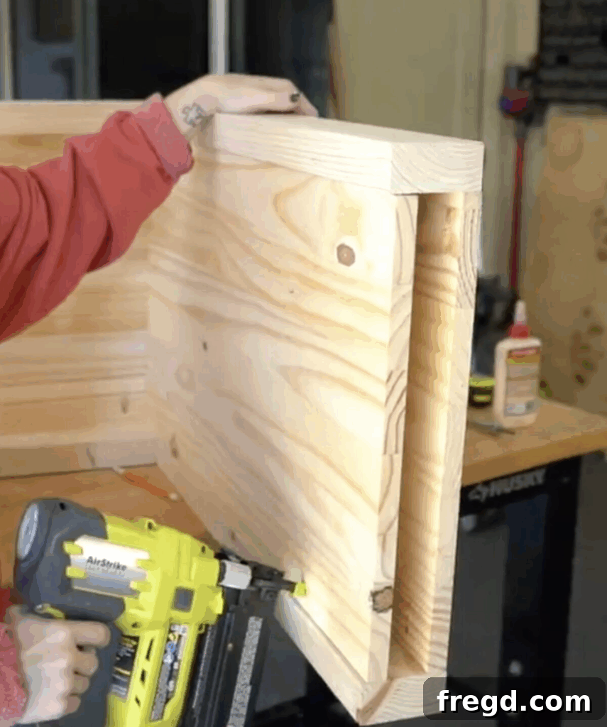 Modern Waterfall Console Build It Yourself for Less Than 100 Dollars 20 Securing cover panels with glue and brad nails