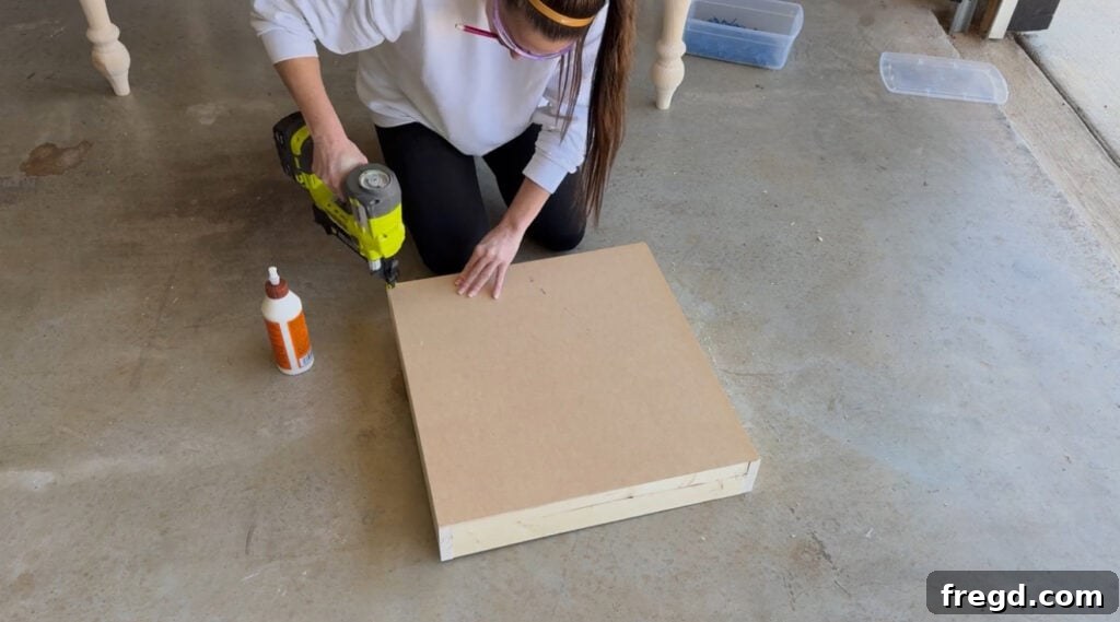 Drawer bottom being attached with staples and glue