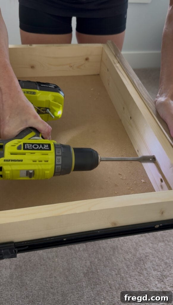 Using a paddle bit to bore out a recess for the drawer pull screw