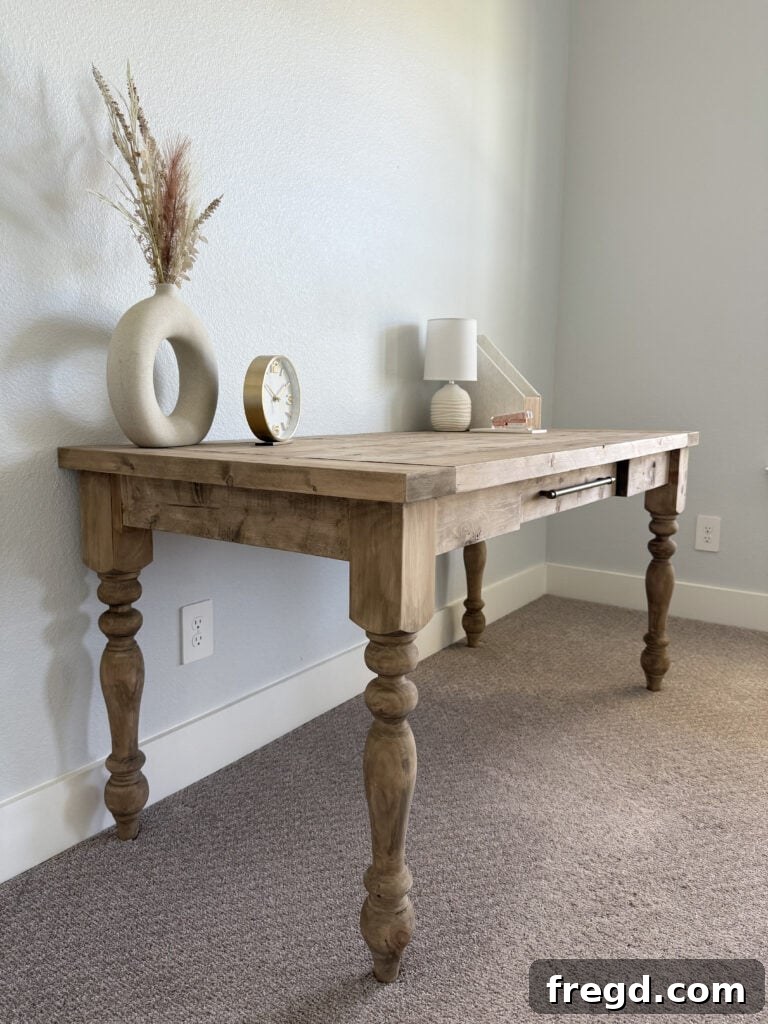 Close-up of the desk's turned legs and drawer pull