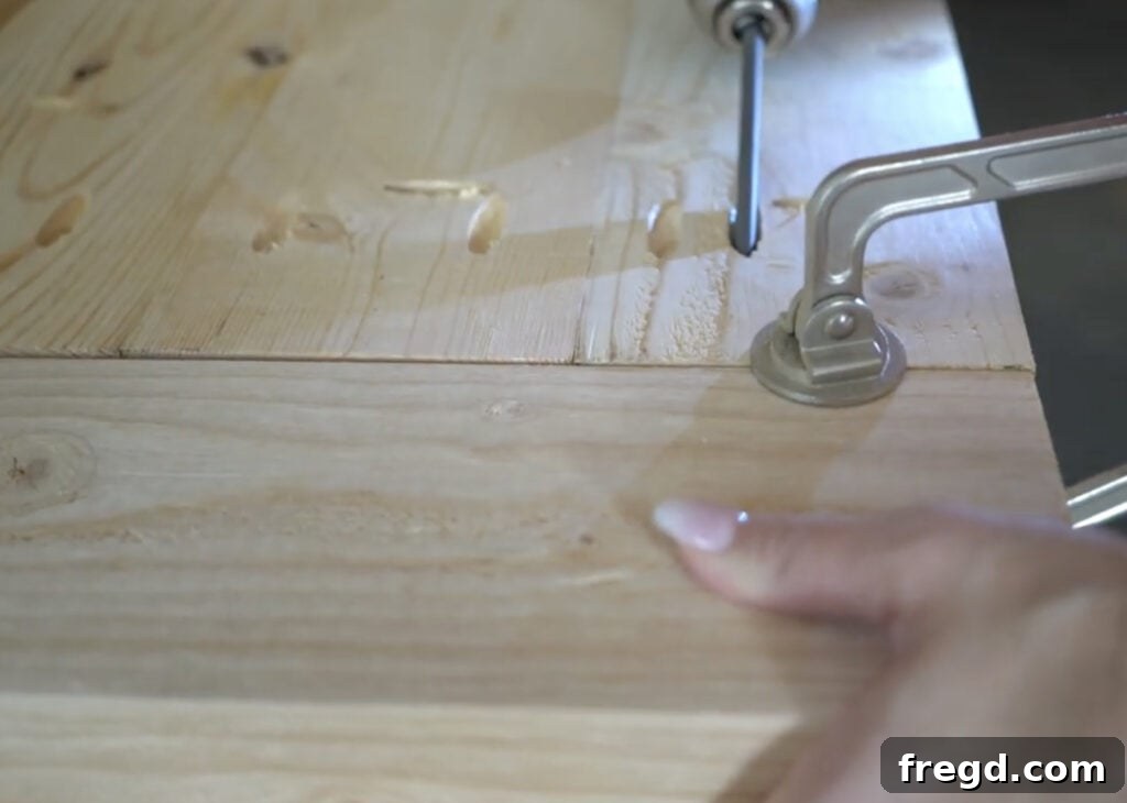 Breadboard ends being attached to the planked tabletop