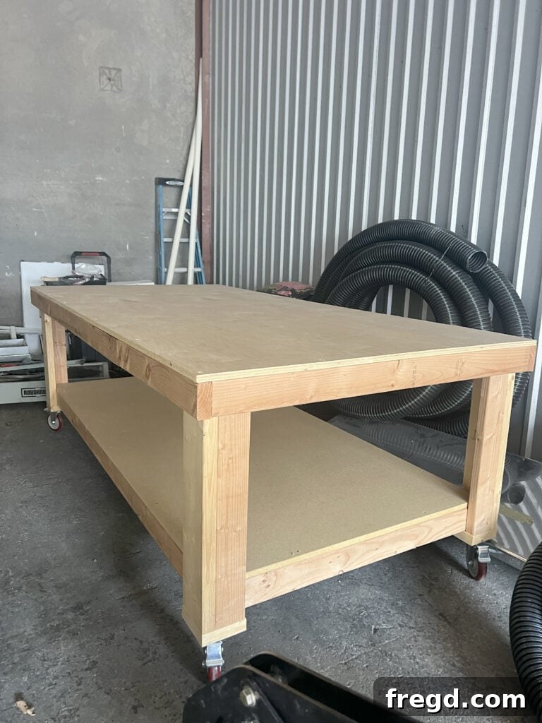 Ultimate DIY 4x8 Workbench With Free Plans 2 Finished 4x8 Heavy-Duty Workbench in a workshop setting.