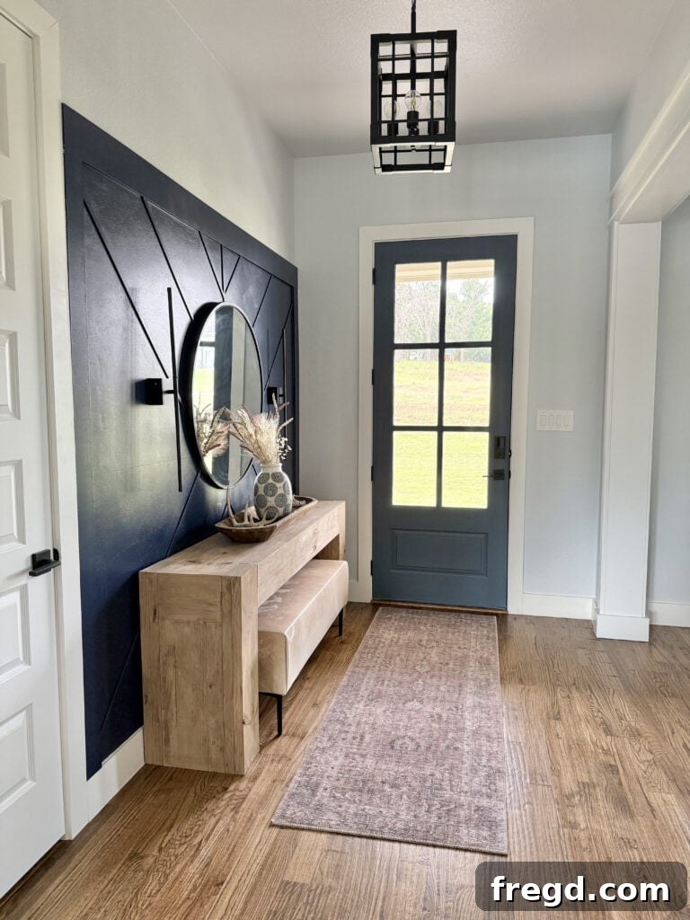 The finished DIY cowhide bench with sleek black metal legs, perfectly styled in an inviting entryway setting.