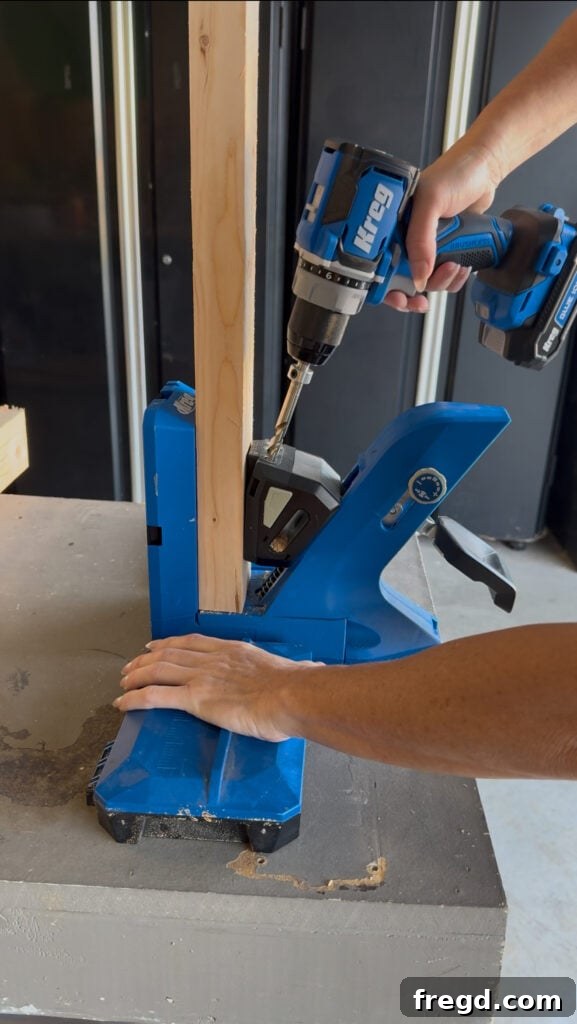 Drilling precise pocket holes into 2x4 lumber with a Kreg Jig 720Pro and a Kreg 20 Volt Ionic Drive Drill for the DIY bench frame.
