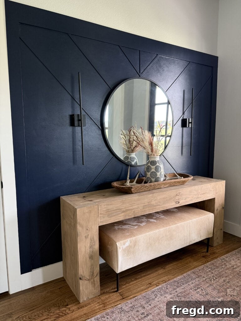 A custom cowhide upholstered bench thoughtfully styled behind a living room sofa, offering both beauty and functional seating.
