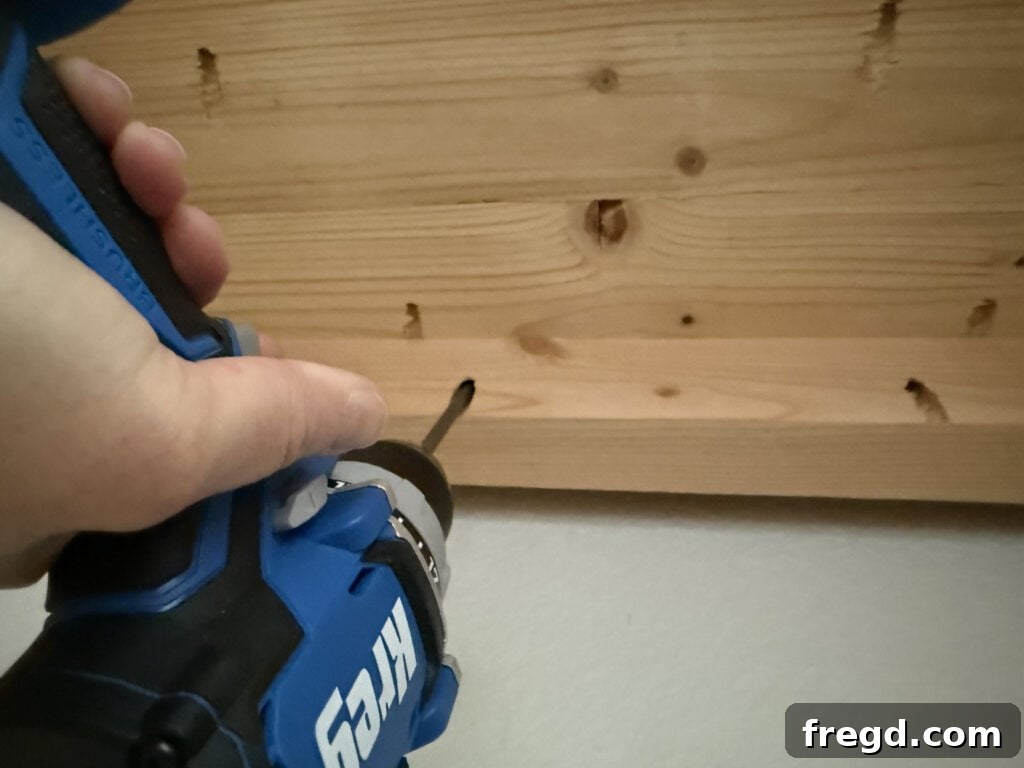 Securing the planked top to the cabinet base with hidden pocket hole screws.
