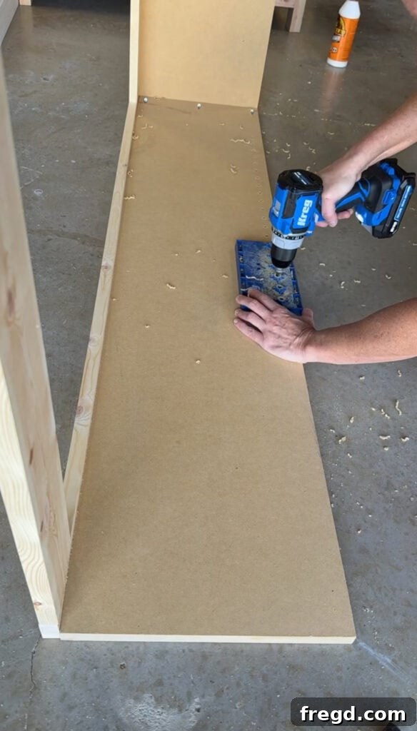 Drilling shelf pin holes into the hutch side panels for adjustable shelves.