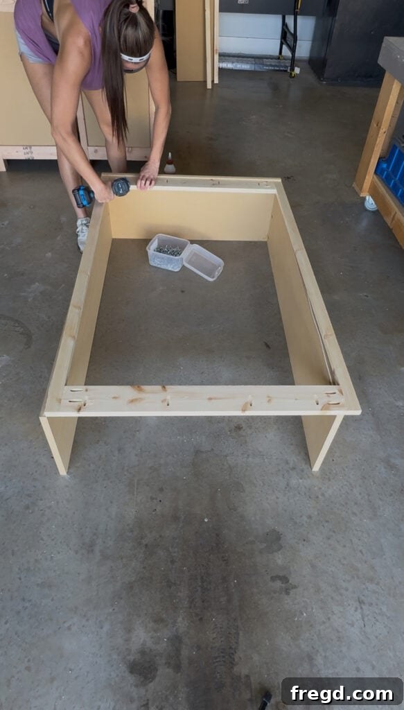 Attaching the back frame to the hutch, ensuring flush alignment.