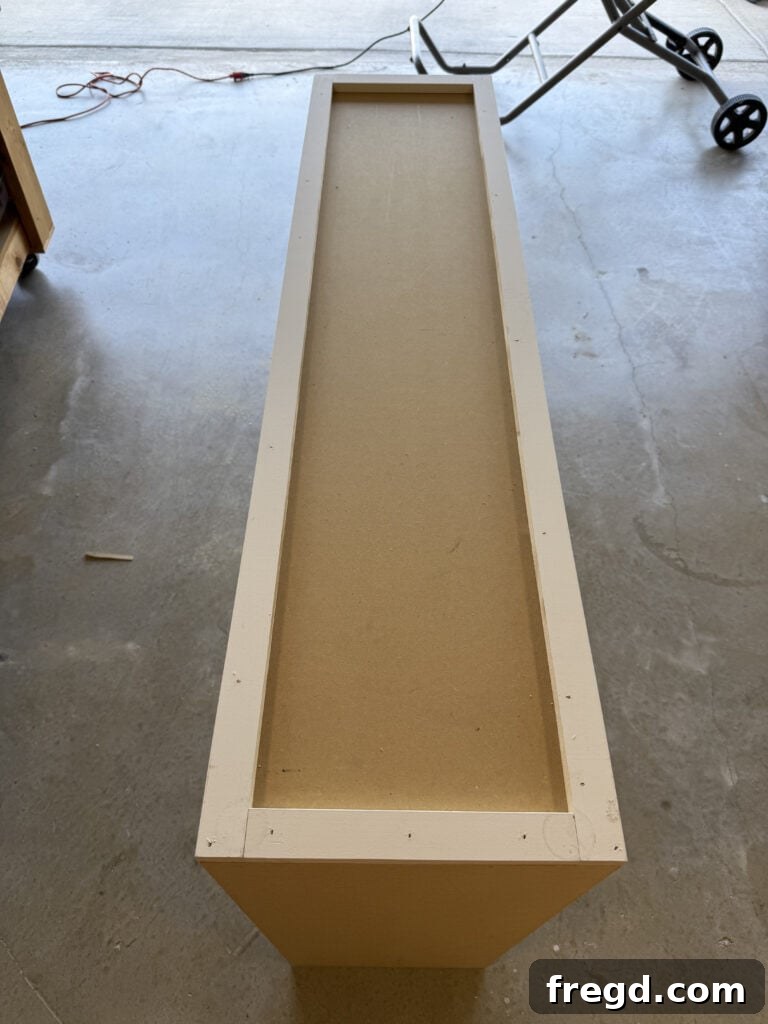 Attaching the side trim assemblies to the hutch with brad nails and wood glue.
