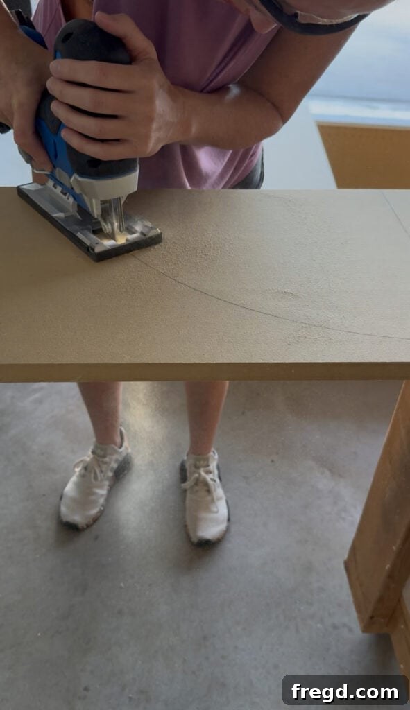 Cutting the arched top piece for the face frame with a jigsaw.