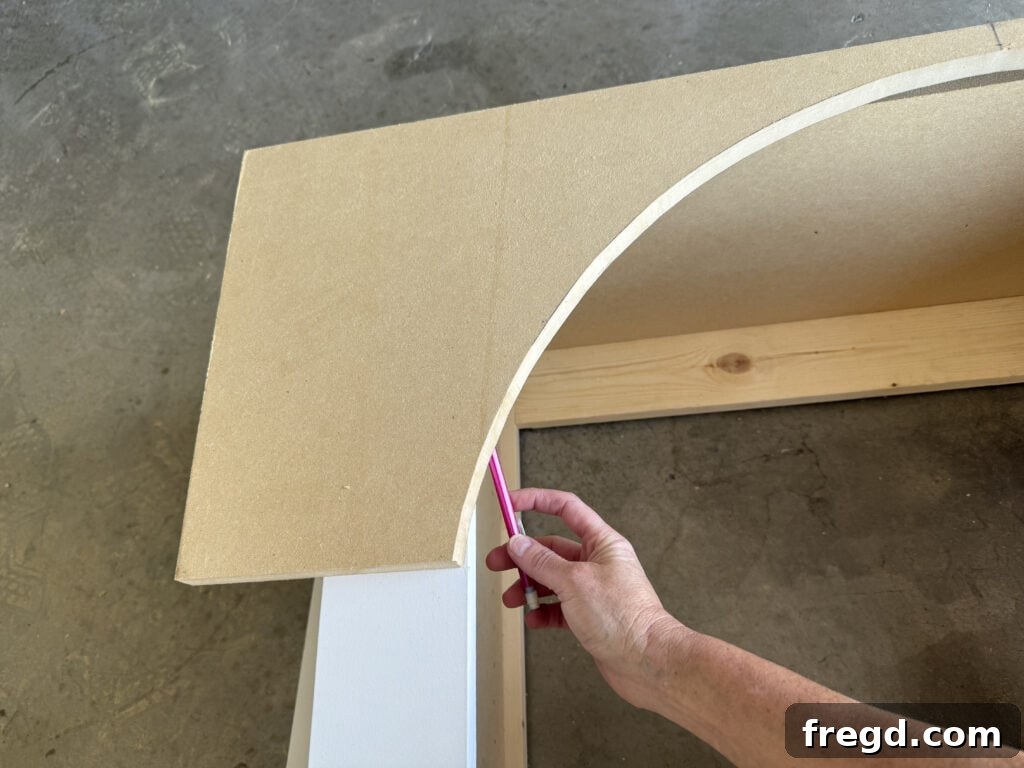 Marking the arch piece on the back to ensure a perfect fit with the face frame.