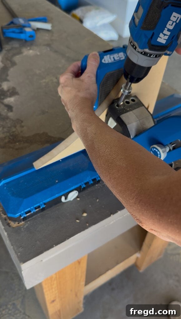 Drilling pocket holes into the ends of the arch and the bottom of the face frame sides.