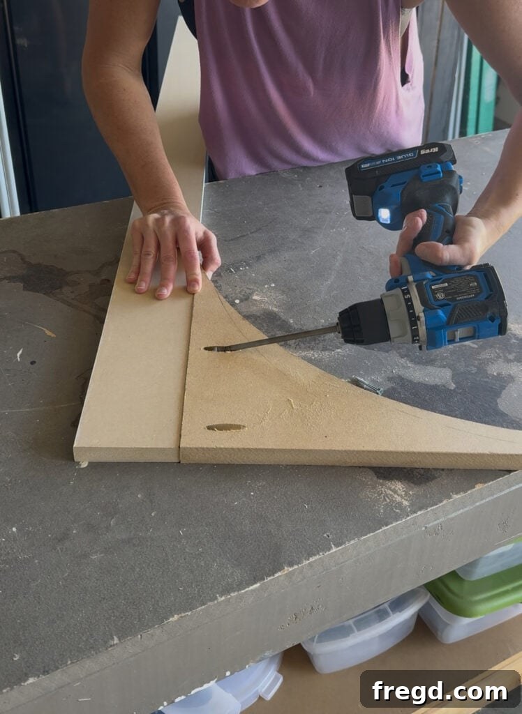 Attaching the arched piece to the side face frame boards with pocket hole screws and wood glue.