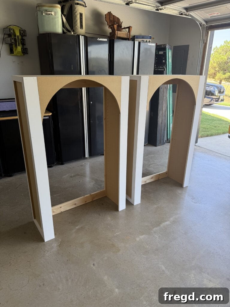 Two completed hutch structures with arched face frames, ready for backing.