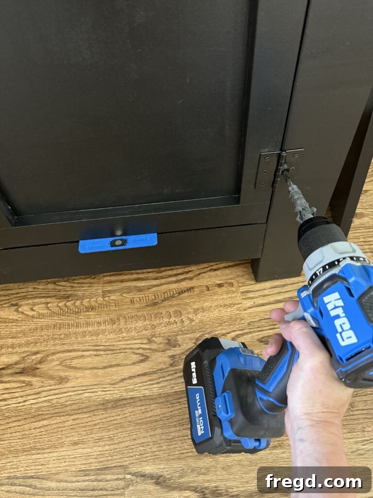 Attaching cabinet doors with hinges and ensuring consistent gaps.