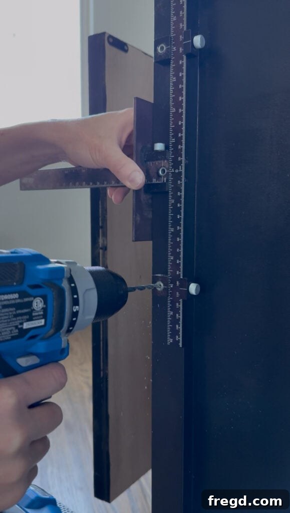 Spraying cabinet pulls black to match the bookcase finish.