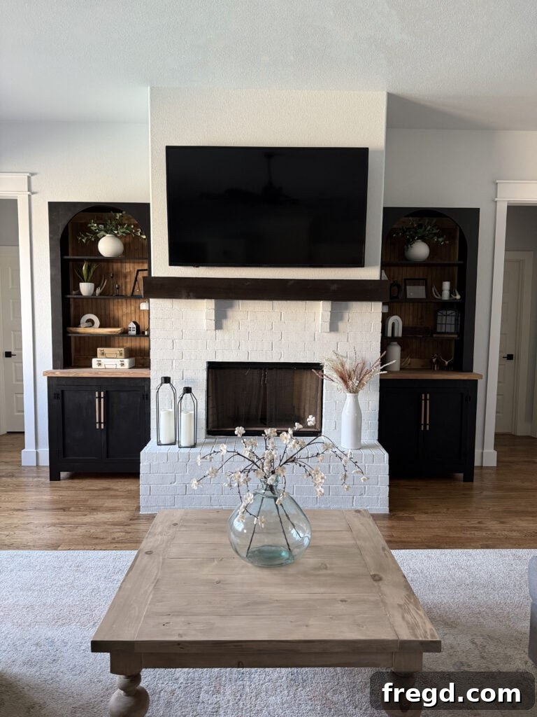 The elegant arched bookcases flanking a fireplace, showcasing their custom design.